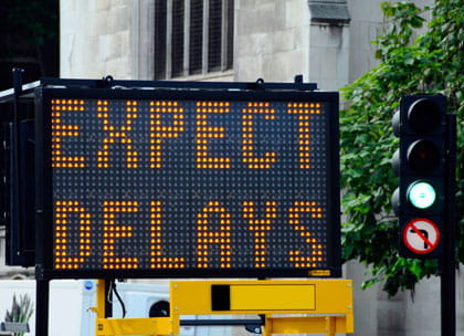 Road sign showing delays